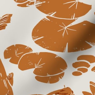 Koi fish and water lily pads in pond burnt orange