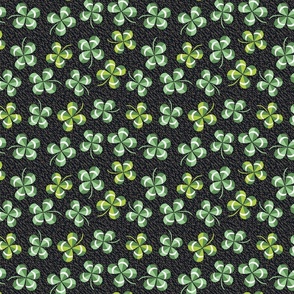 green four-leaf clover on dark brown | small