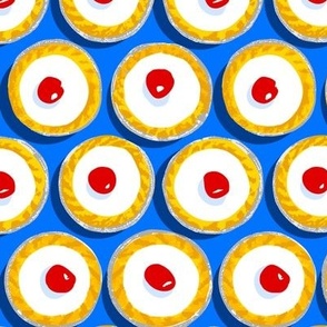 Cherry Bakewells on bright blue background