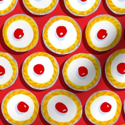 Cherry Bakewells on bright red background