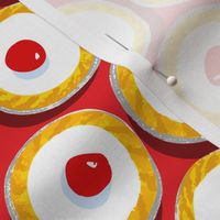 Cherry Bakewells on bright red background