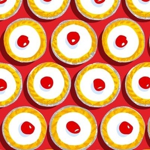 Cherry Bakewells on bright red background