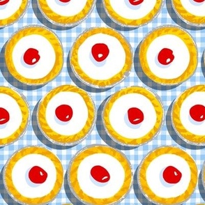 Cherry Bakewells on light blue gingham check background