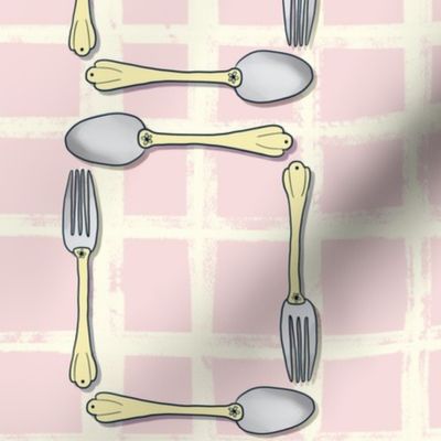 Butter yellow and piglet pink fork and spoon on lined background