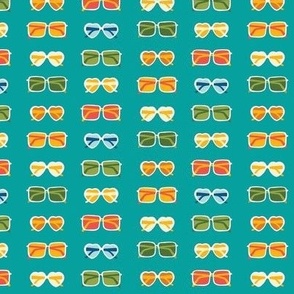 Colorful sunglasses in various shapes on teal blue - summer fabric, home decor