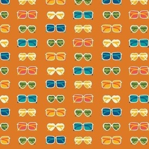 Colorful sunglasses in various shapes on burnt orange - summer fabric, home decor