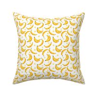 Bright yellow bananas on white