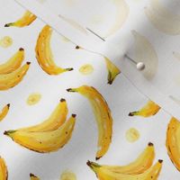 Bright yellow bananas on white