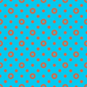Orange rings and dots on a bright blue background