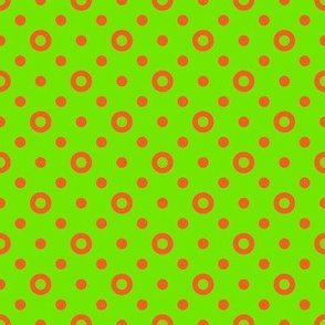 Orange rings and dots on a bright green background
