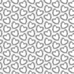 Black dotted hearts on white background