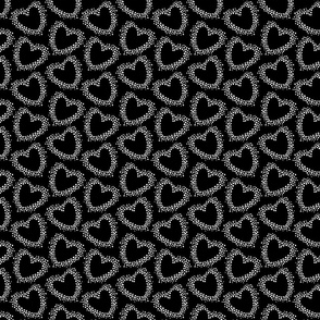 Dotted white  hearts on black background 