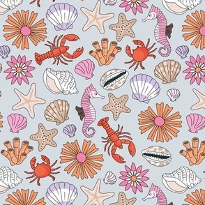 Summer ocean blossom coral shells and sea creatures starfish crab and lobster lilac pink orange on blue