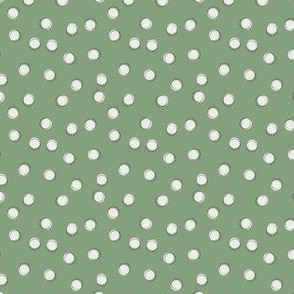 cream polka dots on green