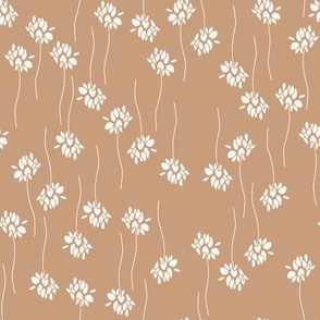 white flowers and twigs in lines on tan brown