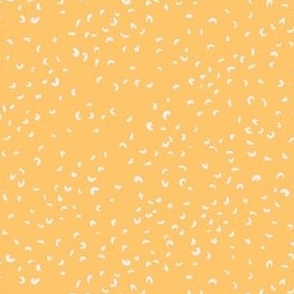 Ditsy scattered dots and dashes in golden yellow