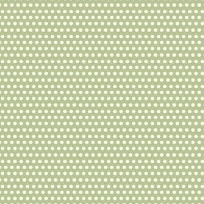 Off-white polka dots on green background