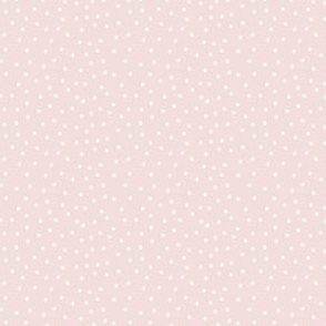 Off-white polka dots on soft pink background