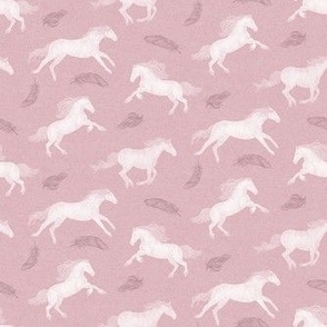 White Horses and feathers on vintage pink background