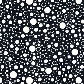 Off-white polka dots on charcoal gray background