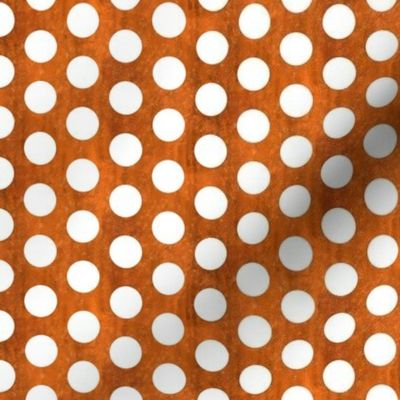 black polka dots on copper-orange textured background