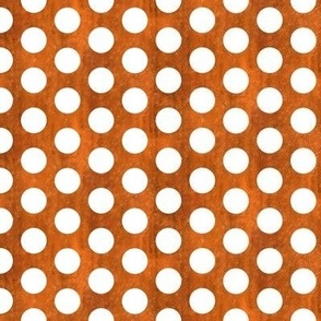 black polka dots on copper-orange textured background