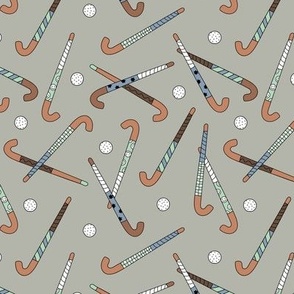 Field Hockey - Honkey sticks and balls tossed freehand boho style sports design mint blue on olive green