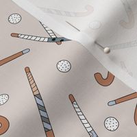 Field Hockey - Hockey sticks and balls tossed freehand boho style sports design beige cool gray blue on sand