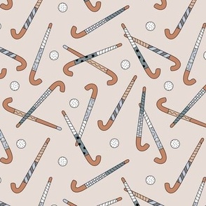 Field Hockey - Hockey sticks and balls tossed freehand boho style sports design beige cool gray blue on sand
