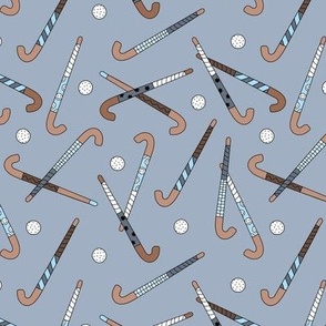 Field Hockey - Hockey sticks and balls tossed freehand boho style sports design cool gray on moody blue