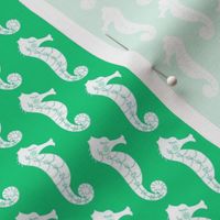 tiny seahorses on green