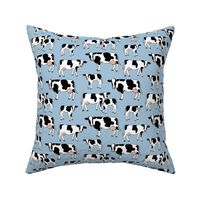 On the farm - cows in black and white spring meadow ink sketched animals American cattle ranch design on sky blue