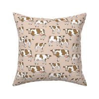 On the farm - brown and white cows spring meadow ink sketched animals American cattle ranch design on soft beige sand