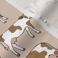 On the farm - brown and white cows spring meadow ink sketched animals American cattle ranch design on soft beige sand