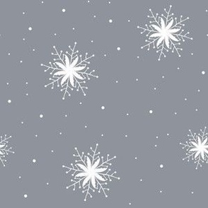 White snowflakes on grey slate background
