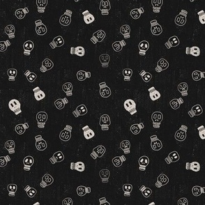 Hand drawn Halloween skulls in off white on a black textured background