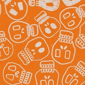 white skulls on orange