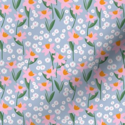 Daffodils and daisies - springtime flowers and leaves summer garden colorful pink pine green orange on sky blue