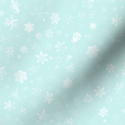 photographic snowflakes on pale ice blue