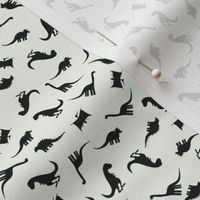 Small Scale Tossed Dinosaurs - Tossed Black Dinosaurs on an off white background