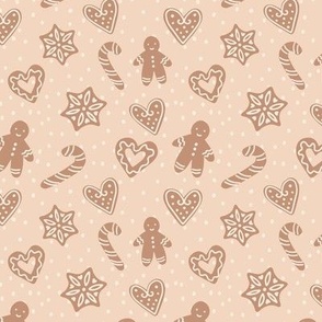 Gingerbread men, stars, hearts, on peachy background