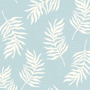 Light yellow tropical leaves on textured blue background