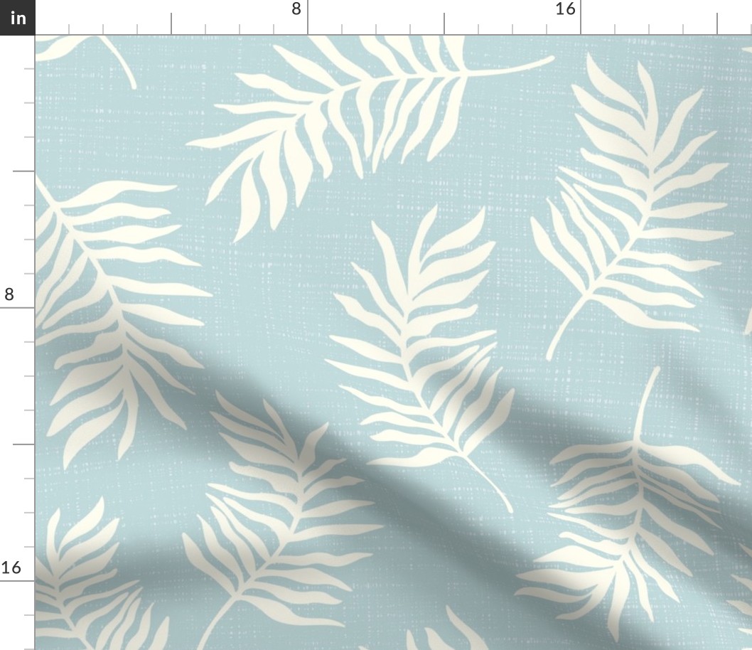 Light yellow tropical leaves on textured blue background