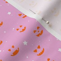 Jack O Lantern faces, bright halloween fabric, orange on pink