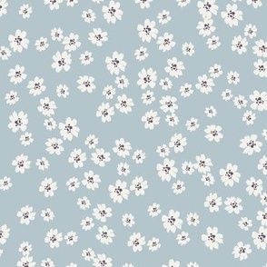 Ivory ditsy flowers tossed on blue