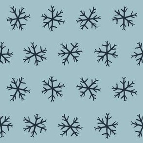 Medium hand drawn arctic snowflakes, snow blender print for gender neutral kids apparel in navy and pastel blue