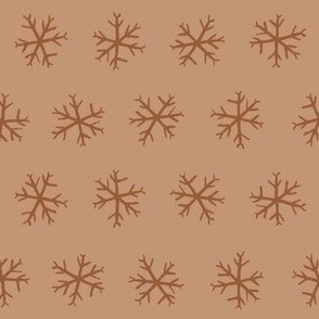 Medium hand drawn arctic snowflakes, snow blender print for gender neutral kids apparel in dark brown and tan