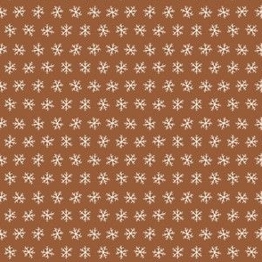 Tiny hand drawn arctic snowflakes, snow blender print for gender neutral kids apparel in dark brown and tan