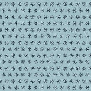 Tiny hand drawn arctic snowflakes, snow blender print for gender neutral kids apparel in navy and pastel blue