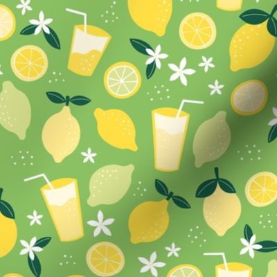 Summer squeeze lemonade - lemons and limes fruit garden drinks and flowers green yellow on grass green